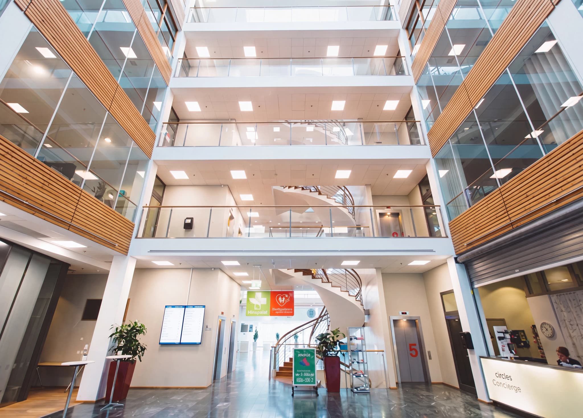 Modern byggnads atrium med reception och trappor